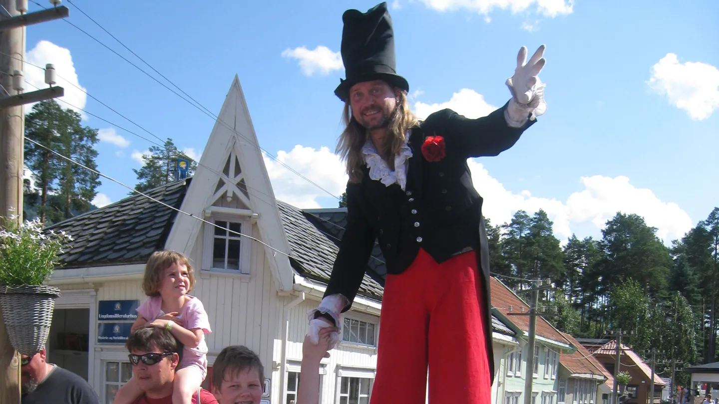 Malte på stylter hilser på barna